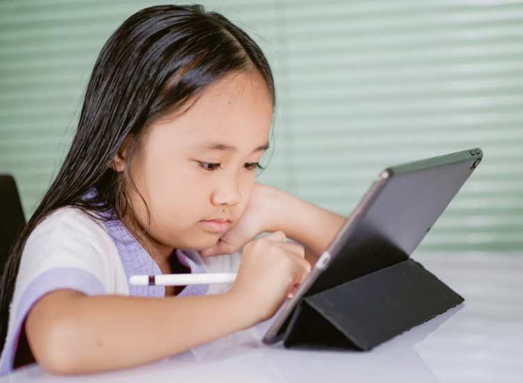 little girl on a tablet